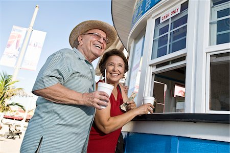 Senior couple buying drinks at food stand Stock Photo - Premium Royalty-Free, Code: 693-06021658