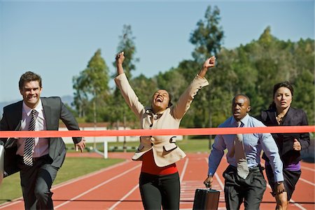 running race winner in women - Business People Crossing the Winning Line Stock Photo - Premium Royalty-Free, Code: 693-06021717