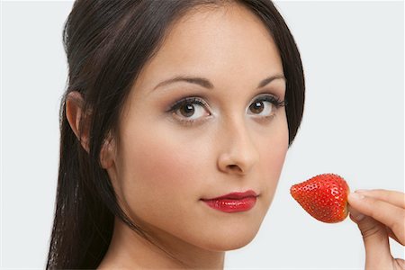 simsearch:693-06021794,k - Woman eating strawberry Stock Photo - Premium Royalty-Free, Code: 693-06021795
