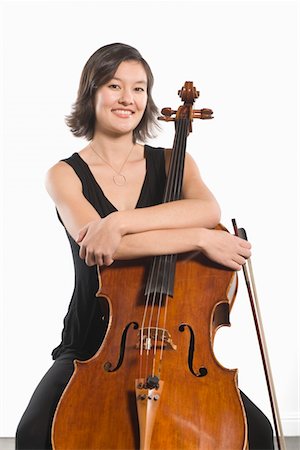Female cellist sits with arms folded across cello Foto de stock - Sin royalties Premium, Código: 693-06021838