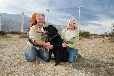 senior couple with pet - Senior couple with dog near wind farm Stock Photo - Premium Royalty-Free, Code: 693-06021954