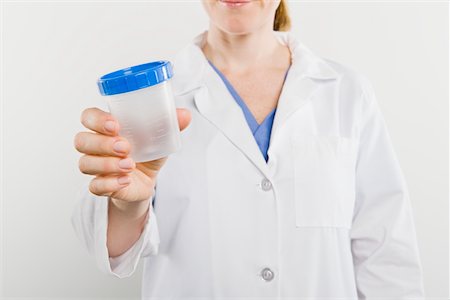 plastic container lid - Doctor with sample pot, mid section Stock Photo - Premium Royalty-Free, Code: 693-06021983