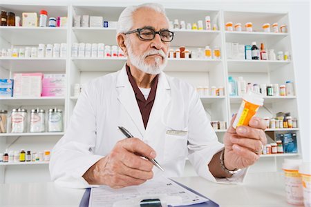 prescription drugs bottles pictures - Male pharmactist working in pharmacy Stock Photo - Premium Royalty-Free, Code: 693-06022002