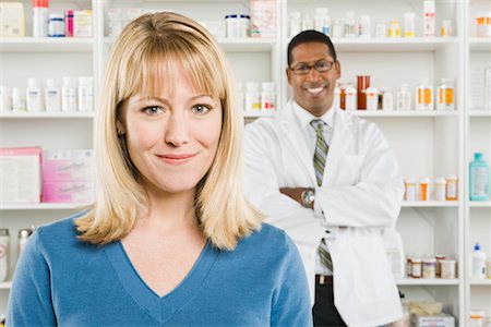 simsearch:694-03332775,k - Woman picking up prescription drugs at pharmacy Stock Photo - Premium Royalty-Free, Code: 693-06022012