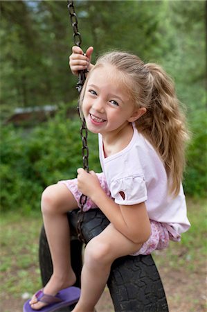 people on swing - Portrait of young swinging on tire Stock Photo - Premium Royalty-Free, Code: 693-06120669