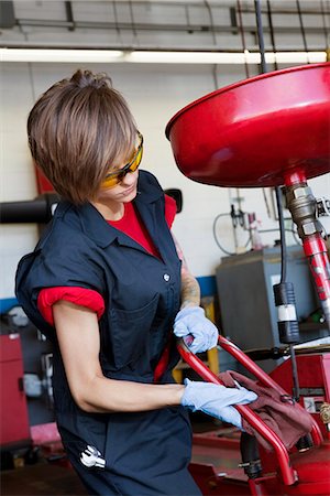 Young female mechanic working on welding equipment Stock Photo - Premium Royalty-Free, Code: 693-06120957