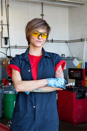 portrait car mechanic - Portrait of a happy mechanic wearing protective gear with arms crossed in auto repair garage Stock Photo - Premium Royalty-Free, Code: 693-06120960