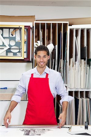 portrait of man in workshop - Portrait of a happy young skilled worker standing with meter stick in workshop Stock Photo - Premium Royalty-Free, Code: 693-06121015