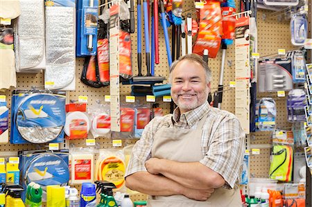 diy - Portrait of a happy mature salesperson with arms crossed in hardware store Foto de stock - Sin royalties Premium, Código: 693-06121044