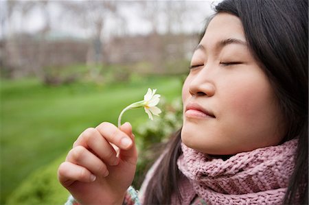 flower park in london - Close-up of a young Asian woman smelling flower in park Stock Photo - Premium Royalty-Free, Code: 693-06121319