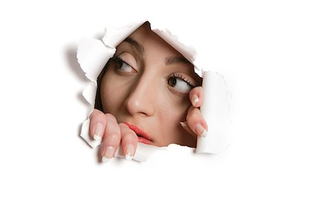 papiere - Young Middle eastern woman looking away from ripped paper hole Stock Photo - Premium Royalty-Free, Code: 693-06121329