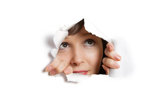 people looking at papers - Young Caucasian woman peeking from ripped paper hole Stock Photo - Premium Royalty-Free, Code: 693-06121334