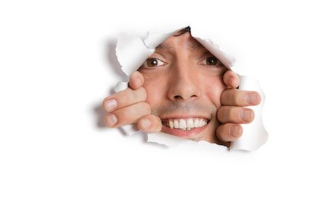 rasgar - Portrait of a happy young Hispanic man peeking from ripped paper hole Foto de stock - Sin royalties Premium, Código: 693-06121330