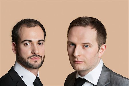 staring - Portrait of young businessmen over colored background Stock Photo - Premium Royalty-Free, Code: 693-06121407