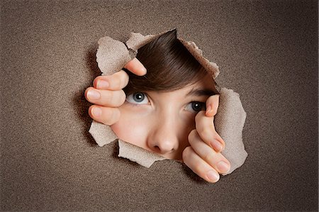 paper face - Middle eastern woman peeking from ripped white paper hole Stock Photo - Premium Royalty-Free, Code: 693-06324090