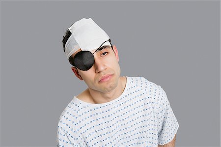 patient sad - Male patient wearing an eye patch suffering from head injury Stock Photo - Premium Royalty-Free, Code: 693-06324319