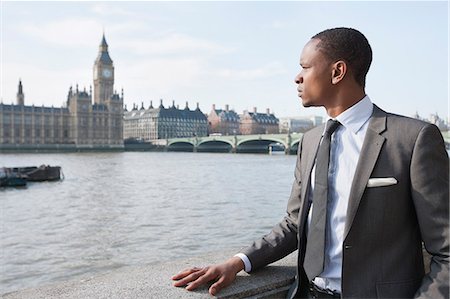 professional business - African American businessman looking at buildings Stock Photo - Premium Royalty-Free, Code: 693-06324368