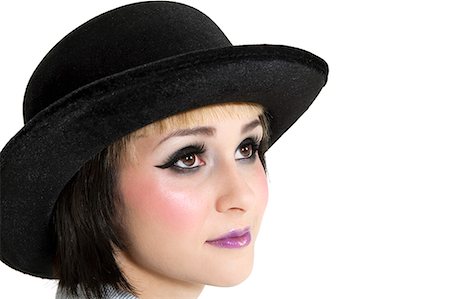 Close-up of young woman wearing hat over white background Stock Photo - Premium Royalty-Free, Code: 693-06324421