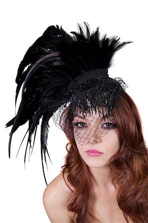 feather - Portrait of young brunette wearing feathered veil over white background Stock Photo - Premium Royalty-Free, Code: 693-06324535