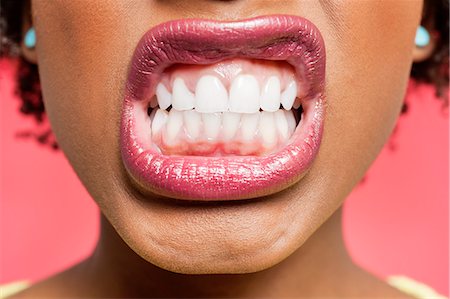 simsearch:693-06324635,k - Cropped image of woman clenching teeth Stock Photo - Premium Royalty-Free, Code: 693-06324641