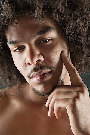 Portrait of young man with curly hair Stock Photo - Premium Royalty-Free, Code: 693-06324711