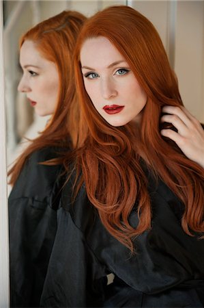 redhead young woman portrait - Portrait of a beautiful young woman in robe with hand in hair Stock Photo - Premium Royalty-Free, Code: 693-06324741