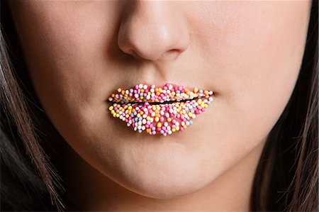 Cropped image of Caucasian woman with sprinkle candy lips Stock Photo - Premium Royalty-Free, Code: 693-06324774