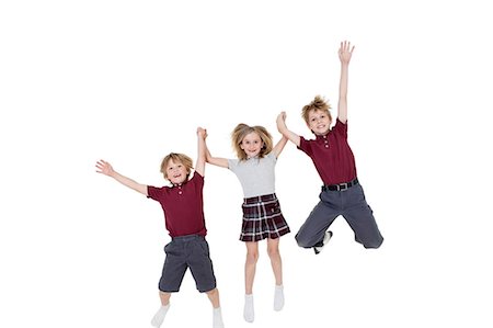 Portrait d'écoliers heureux, main dans la main tout en sautant sur fond blanc Photographie de stock - Premium Libres de Droits, Code: 693-06324788