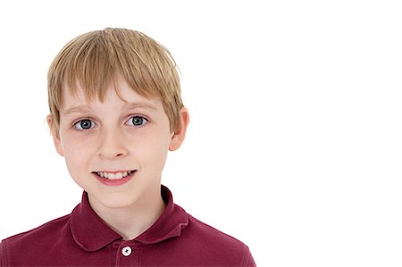 portrait of boy isolated - Close-up portrait of a happy pre-teen boy over white background Stock Photo - Premium Royalty-Free, Code: 693-06324797