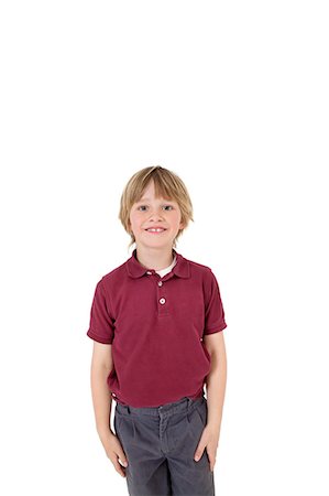 Portrait of happy elementary boy in school uniform over white background Foto de stock - Sin royalties Premium, Código: 693-06324793