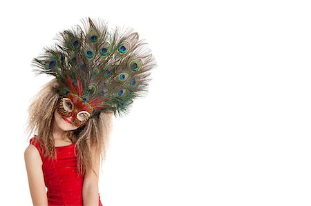 Portrait of a girl in peacock feather mask over white background Stock Photo - Premium Royalty-Free, Code: 693-06324847