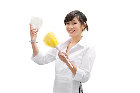 Portrait of a happy female house cleaner dusting glass with feather duster over white background Foto de stock - Royalty Free Premium, Número: 693-06324896