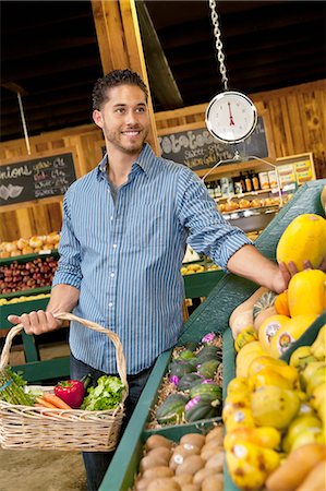 Handsome young man shopping for fruits in supermarket Stock Photo - Premium Royalty-Free, Code: 693-06324922