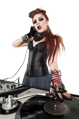 dj - Portrait of beautiful punk DJ with sound mixing equipment over white background Stock Photo - Premium Royalty-Free, Code: 693-06324977