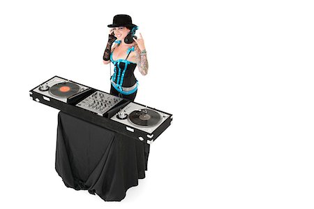 Portrait of female DJ gesturing rock sign over white background Stock Photo - Premium Royalty-Free, Code: 693-06324985