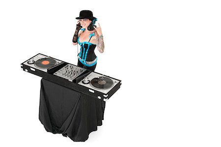 punk - Portrait of female DJ gesturing rock sign over white background Fotografie stock - Premium Royalty-Free, Codice: 693-06324985