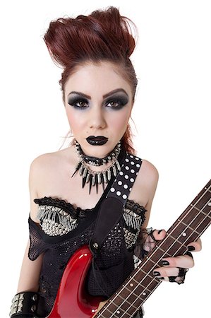 rocker - Portrait beautiful punk woman staring while holding guitar over white background Stock Photo - Premium Royalty-Free, Code: 693-06325001