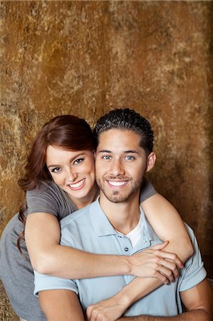 romanticism - Portrait of happy young woman hugging man from behind Stock Photo - Premium Royalty-Free, Code: 693-06325111