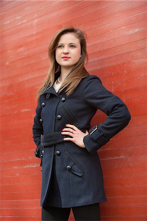 Beautiful young business woman standing with hands on hips looking away Stock Photo - Premium Royalty-Free, Code: 693-06325186