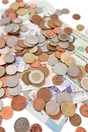 stacks of coins - Close-up of paper currencies and coins Stock Photo - Premium Royalty-Free, Code: 693-06325204