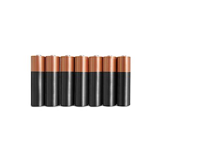 Close-up of batteries in a row over white background Stock Photo - Premium Royalty-Free, Code: 693-06325221