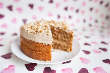 dessert for birthday - Close-up of cake with missing piece over heart shaped background Stock Photo - Premium Royalty-Free, Code: 693-06325239