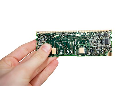 Close-up view of hands holding computer circuit board over white background Stock Photo - Premium Royalty-Free, Code: 693-06325247