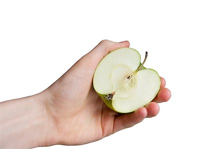 simsearch:693-06325279,k - Cropped image of hand holding sliced apple over white background Stock Photo - Premium Royalty-Free, Code: 693-06325266