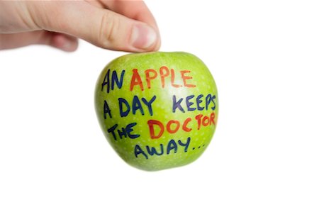 red concept - Cropped image of hand holding a granny smith apple with sayings text over white background Stock Photo - Premium Royalty-Free, Code: 693-06325289