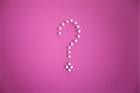 perplexed - Close-up of push pins forming question mark over pink background Stock Photo - Premium Royalty-Free, Code: 693-06325298