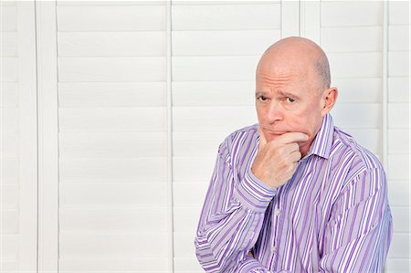 sad bald guy - Senior man in pensive mood with hand on chin Stock Photo - Premium Royalty-Free, Code: 693-06323972