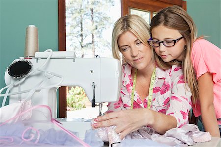 retro mom and child - Little girl looking at mother sewing cloth Stock Photo - Premium Royalty-Free, Code: 693-06378766