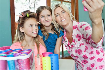 pictures of females in curlers - Mother with daughters taking self portrait with cell phone Stock Photo - Premium Royalty-Free, Code: 693-06378770