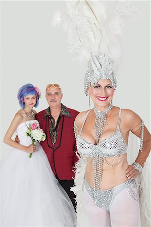 simsearch:693-06379348,k - Portrait of senior showgirl with father and daughter in wedding dress against gray background Stock Photo - Premium Royalty-Free, Code: 693-06378822